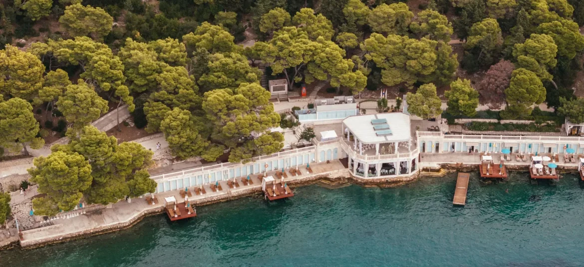 Aerial view of Beach Club Hvar surrounded by lush greenery and crystal clear waters in Hvar, Croatia.